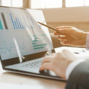 Person analysing business charts on a laptop, reviewing data to inform decisions